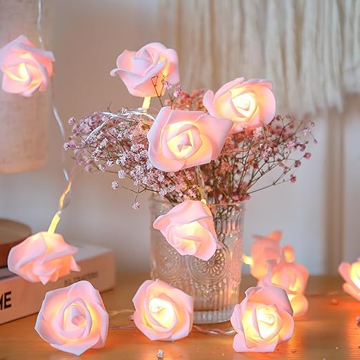 Rose-shaped LED string lights glowing warmly on a vase of flowers, ideal for decorative indoor or outdoor use